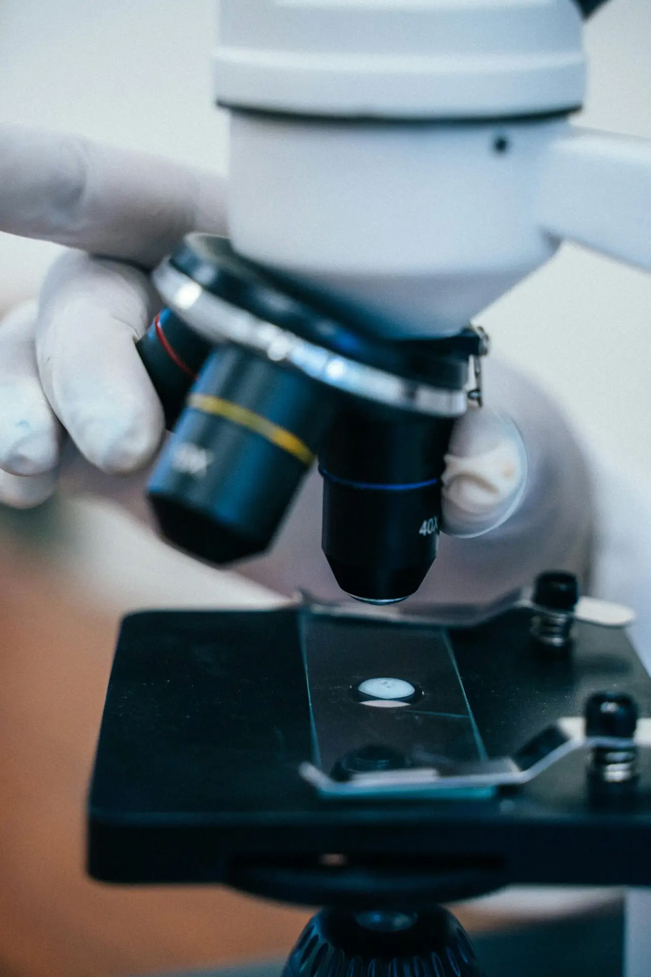 Close-up of a researcher using a microscope for scientific analysis.